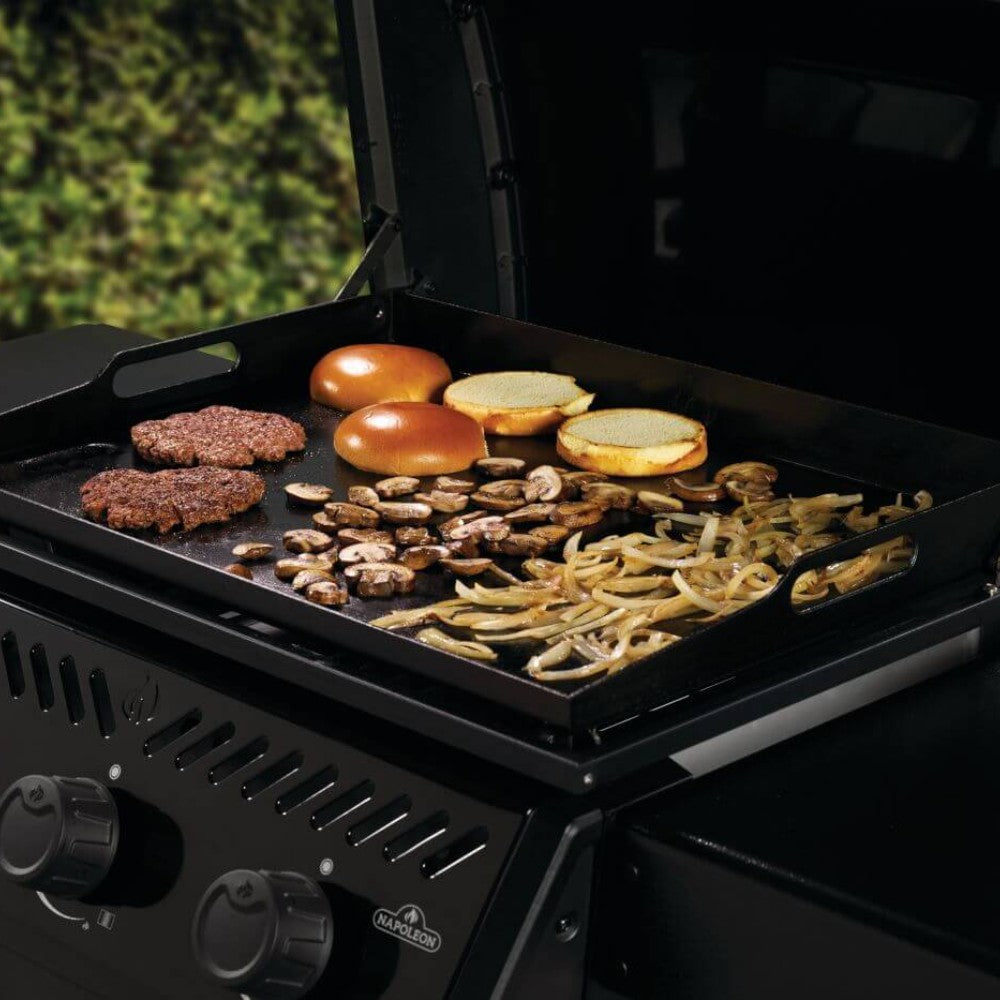 Gas griddle cart cooking surface with burgers, sausages, and sliced onions