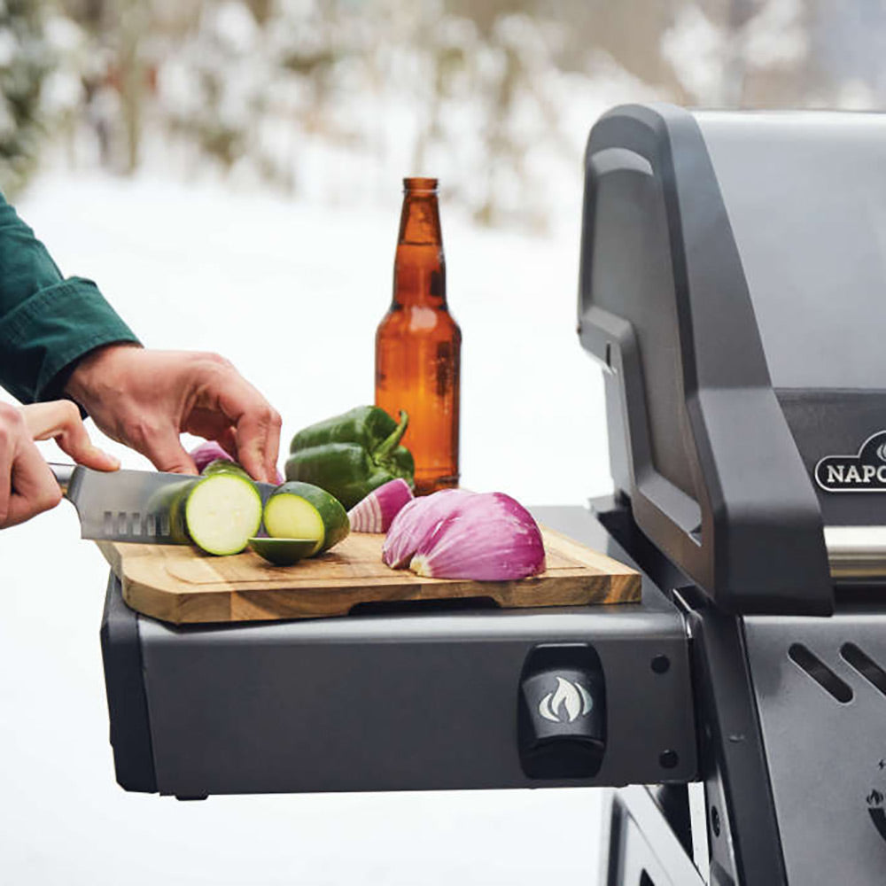 Freestyle 365 gas grill on cart with side tray, vegetables prepped near the grill