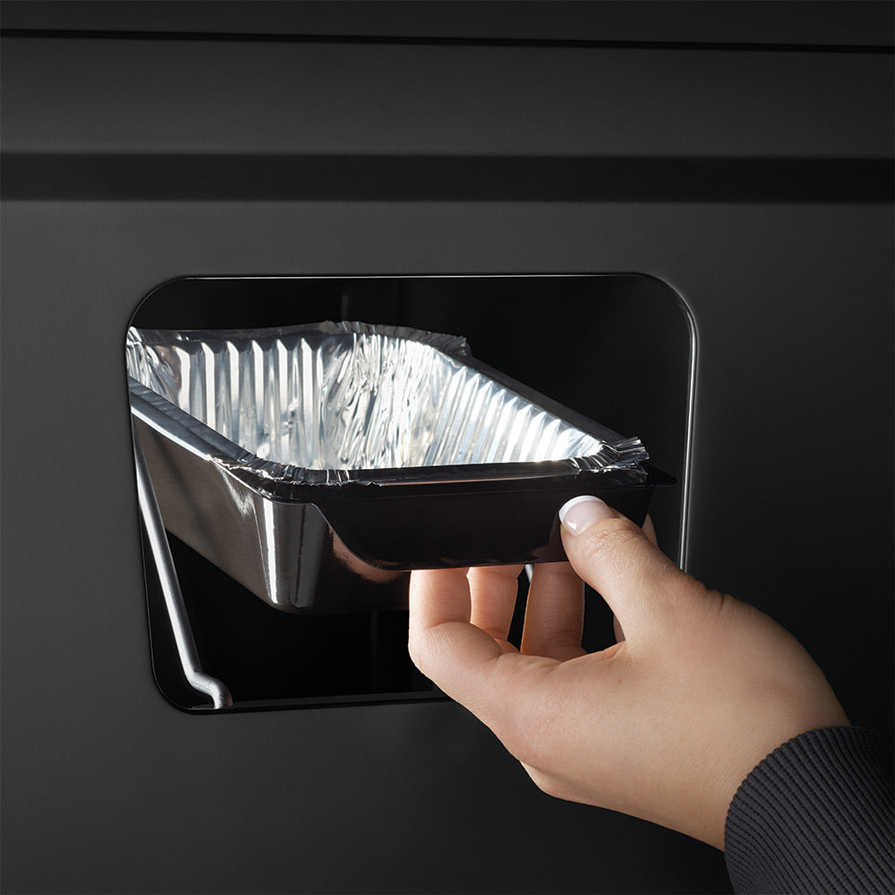 Removable drip tray insert area with hand placing foil-lined pan