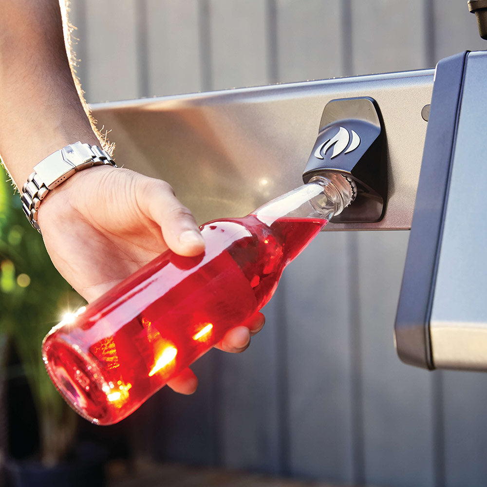 Gas grill control area with bottle being poured near burner, black