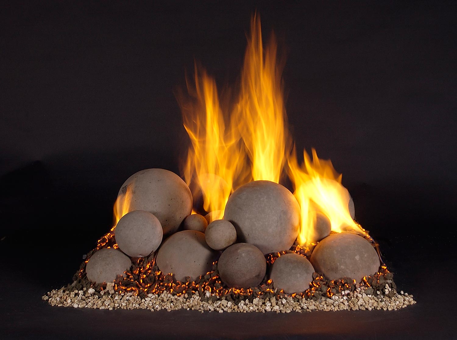 Burning smooth fireballs around a linear fire burner base with glowing flames