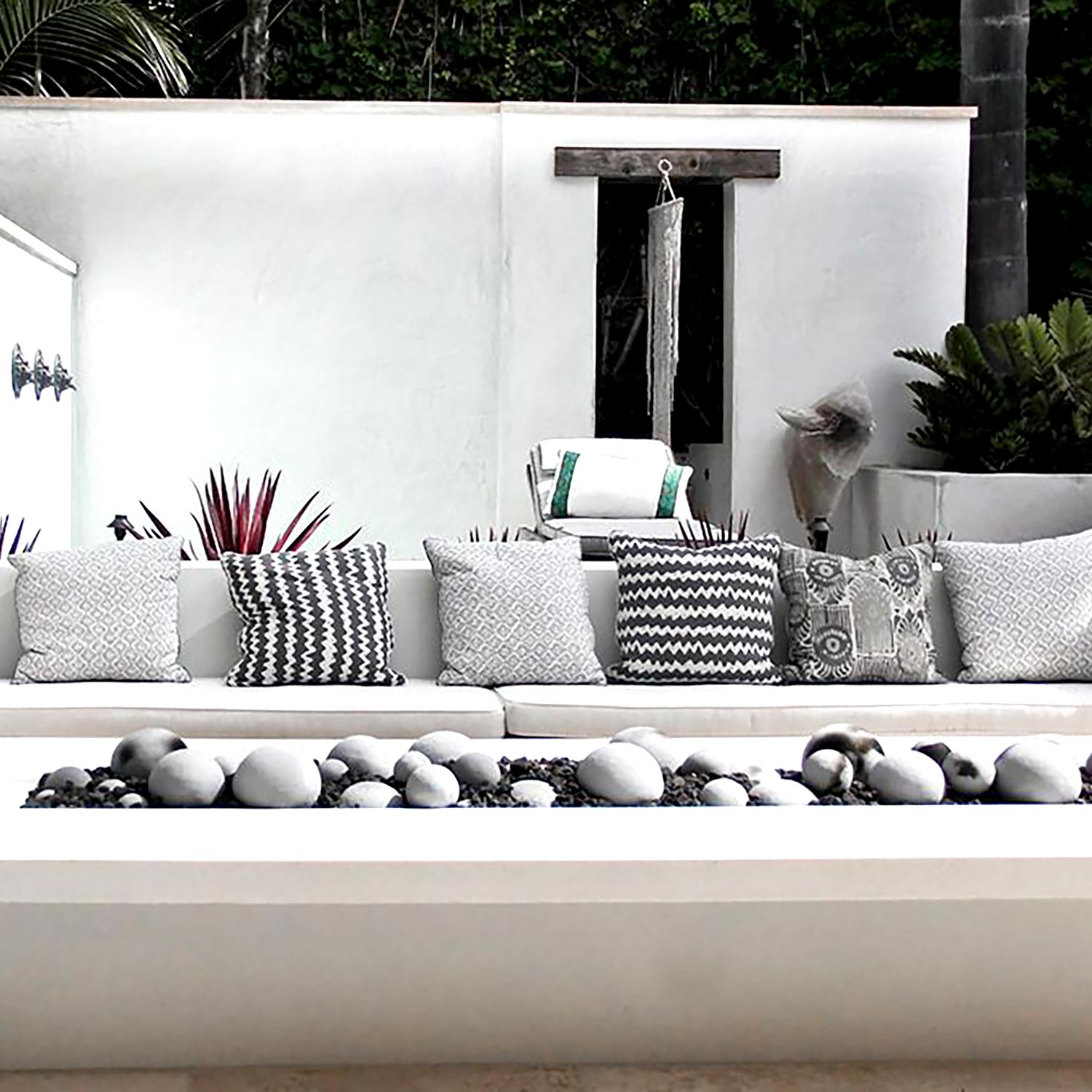 Outdoor linear burner display with smooth FireBall spheres along the bed, mixed gray tones