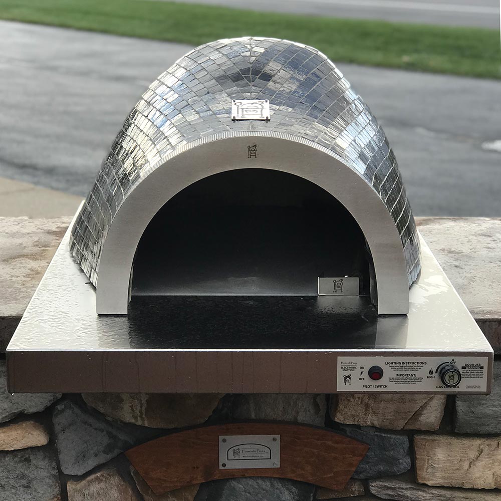 Built-in pizza oven with silver mosaic dome and front firebox opening, control panel visible