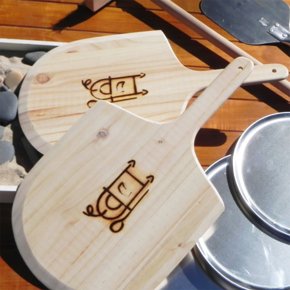 Wooden pizza paddle with rounded board and short handle, stamped logo on top