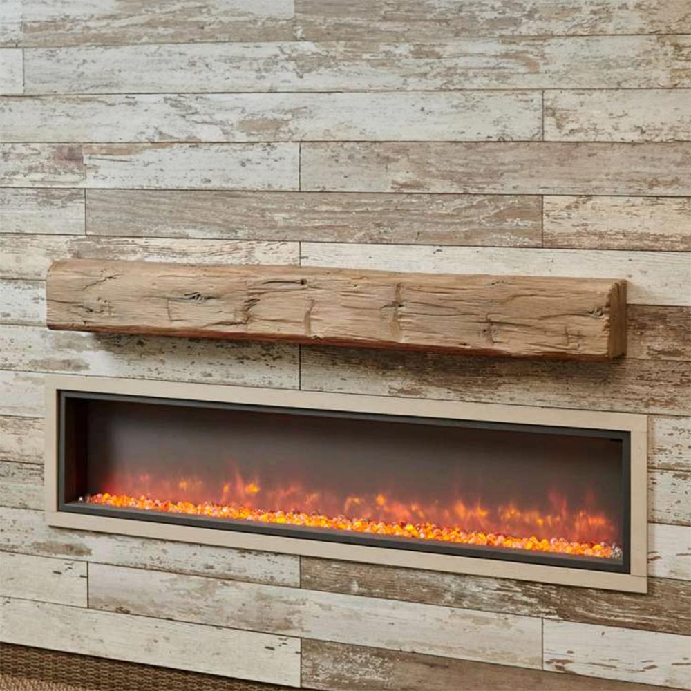 Weathered barnwood mantel shelf over linear fireplace opening with glowing logs