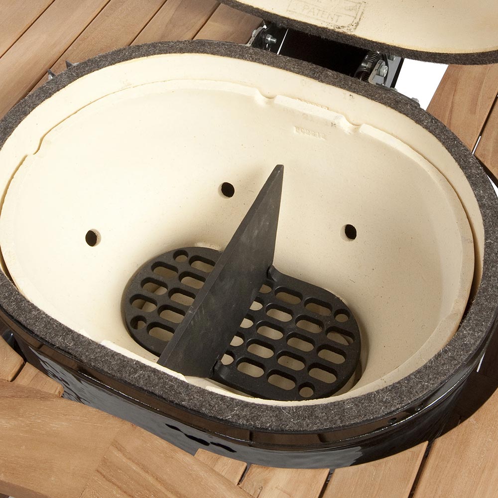 Cast iron oval divider insert in grill opening, upright with perforated cutouts, dark