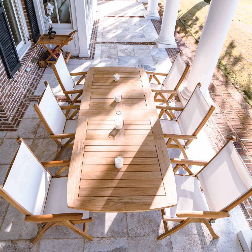 Teak sling chair with white fabric seat and backrest in outdoor dining set