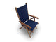 Teak sling chair with navy fabric seat and back, curved armrests and angled teak frame.