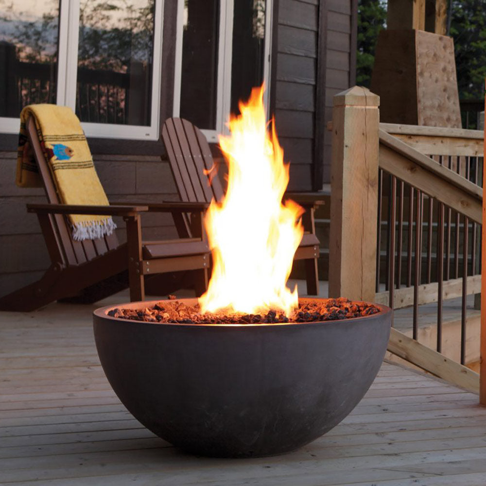 Round gas fire bowl with bright flames and lava rocks, dark gray matte finish