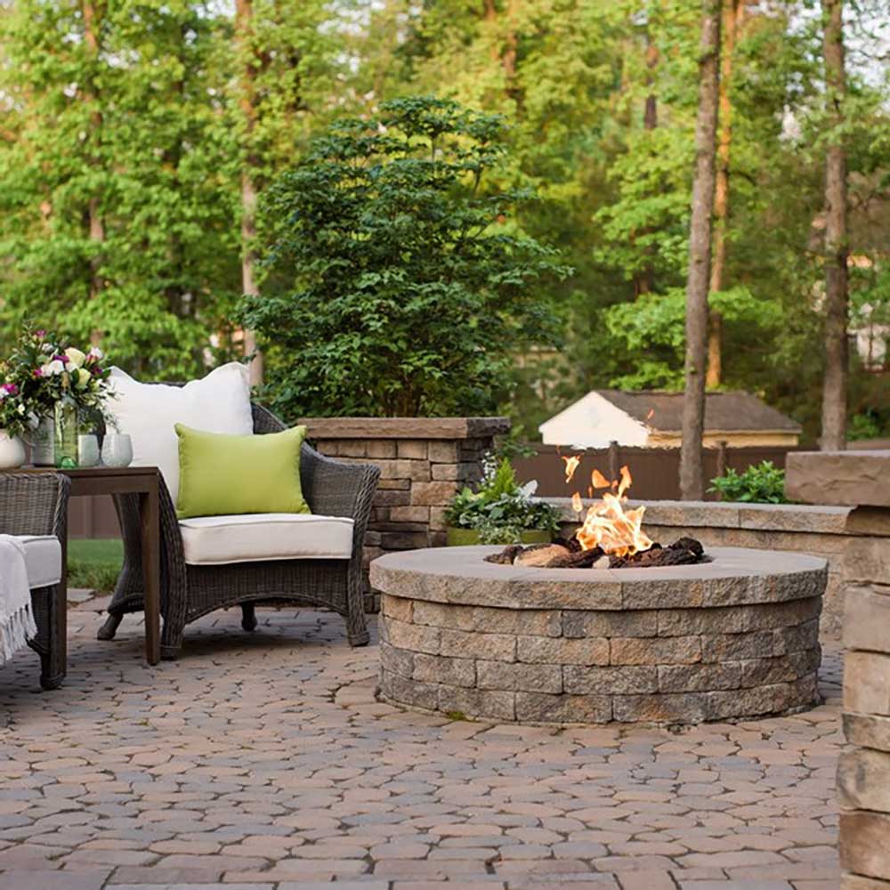 Outdoor gas fire pit flame in a stone ring