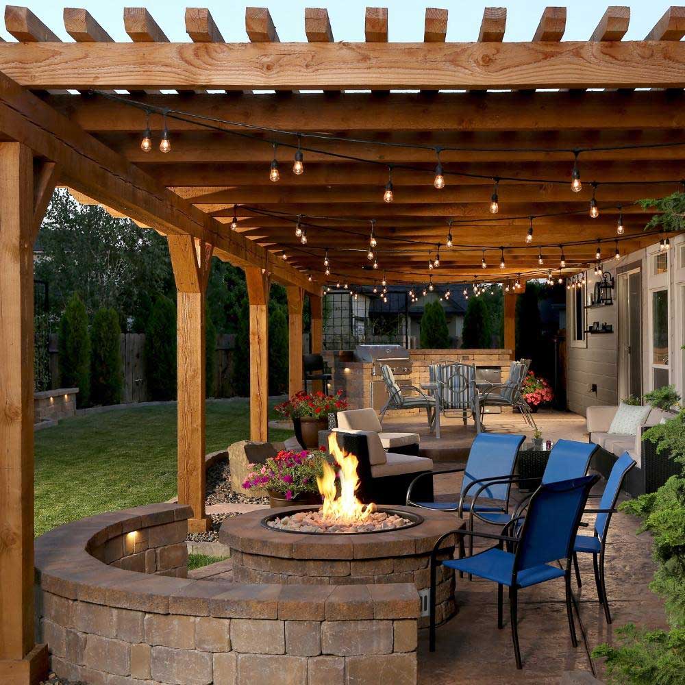 Outdoor circular gas fire pit with stone surround and burning flame