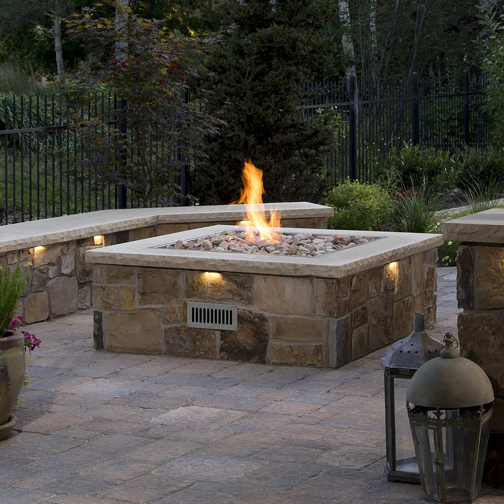 Square stainless steel gas fire pit burner with visible orange flame