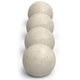 Stack of light gray matte fire spheres, round concrete ball set