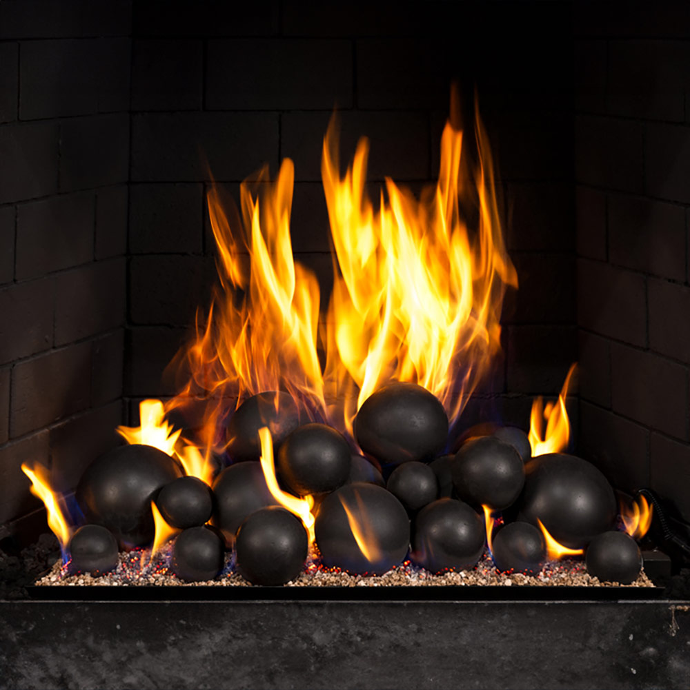 Mixed fire spheres set with black spheres amid burning flames