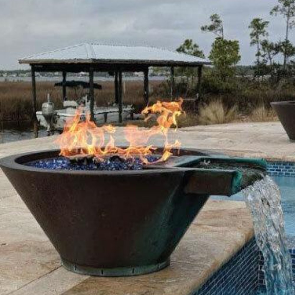 Round copper fire bowl with flames and water spilling over the side edge.
