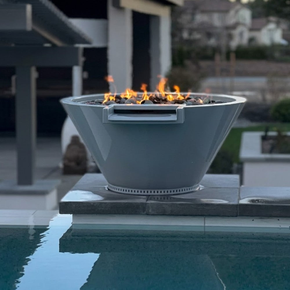 Round gas fire and water bowl with flame visible in the top opening; water reflects nearby
