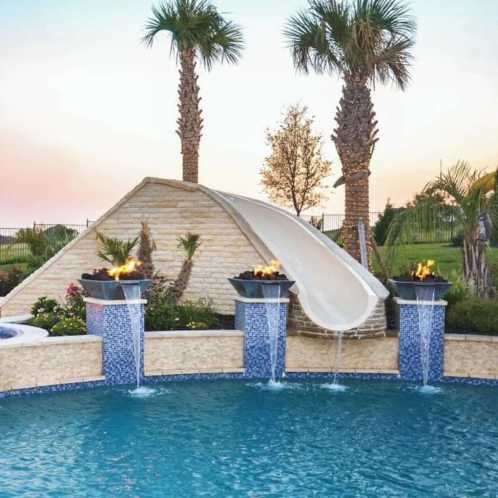 Outdoor concrete fire and water bowl with flames and water spilling into a pool