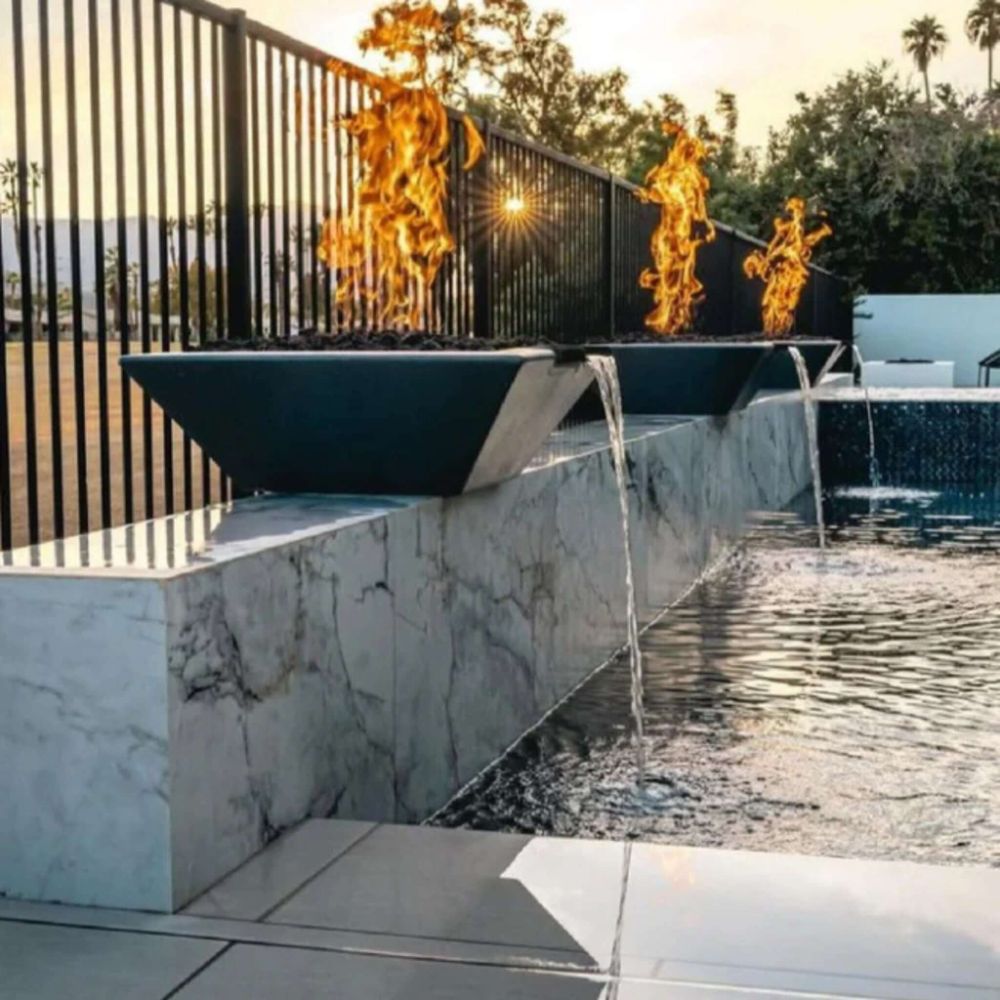 Outdoor concrete fire and water bowl fountain with flames and a steady water stream