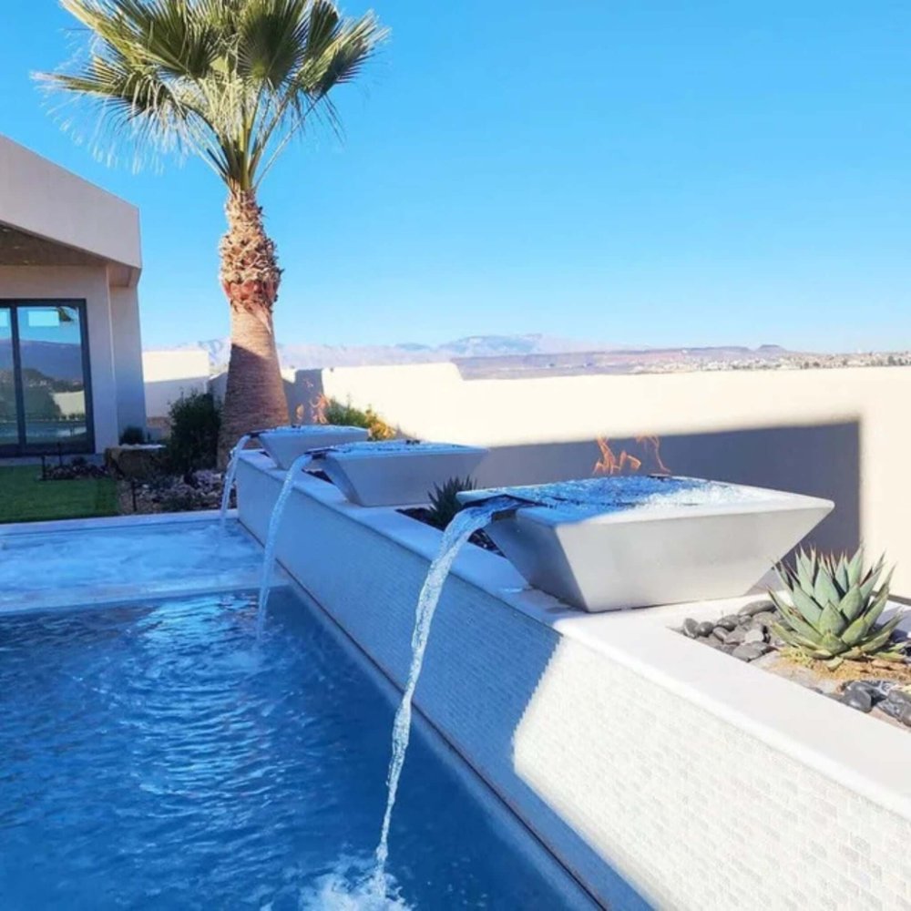 Outdoor concrete fire and water bowl with water flowing from the burner opening