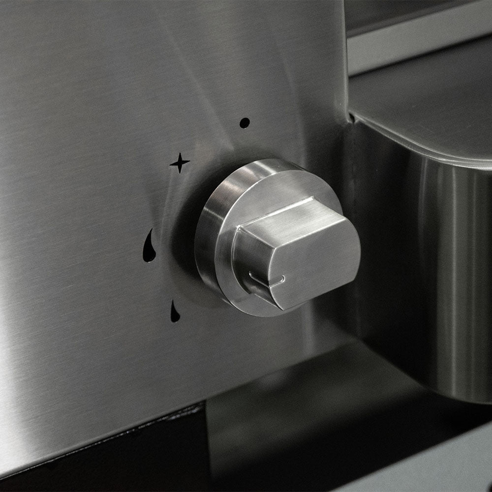Gas pizza oven close-up of stainless steel control knob on side panel