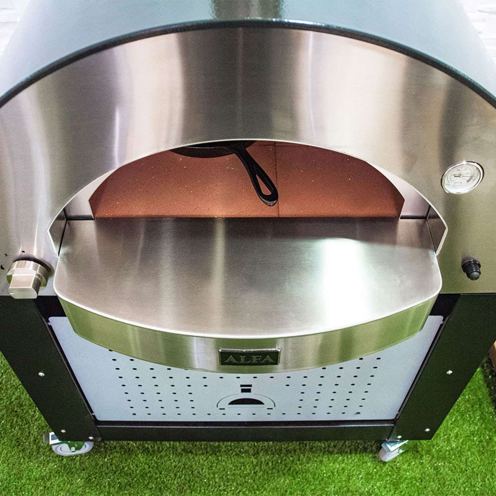 Gas pizza oven front with heated stone and pizza peel-ready interior