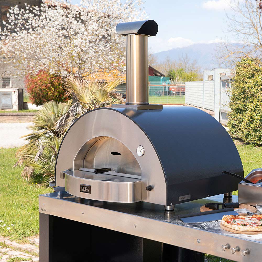 Outdoor stainless gas pizza oven with domed front and open cooking chamber