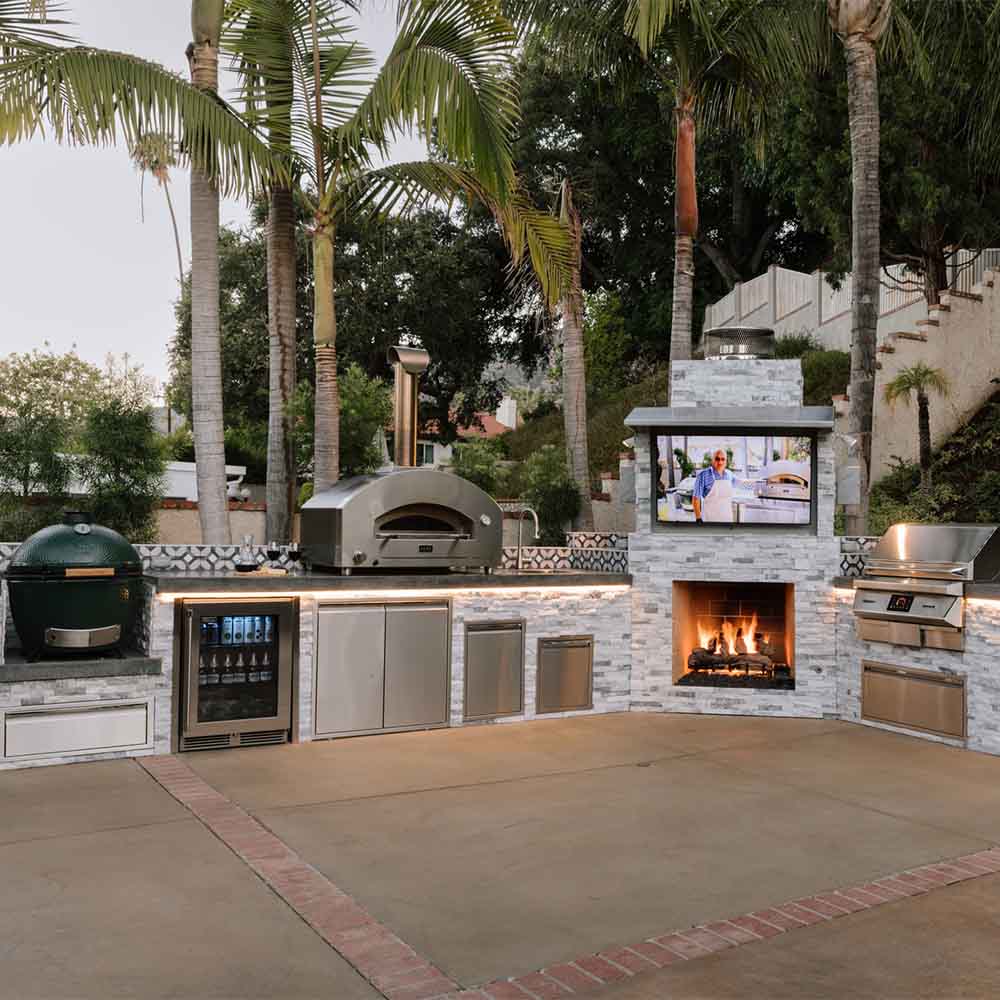 Outdoor countertop pizza oven with stainless housing and open baking chamber.