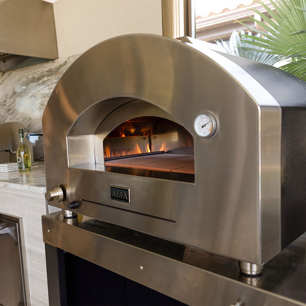 Stainless gas pizza oven front with ALFA badge and illuminated baking chamber.