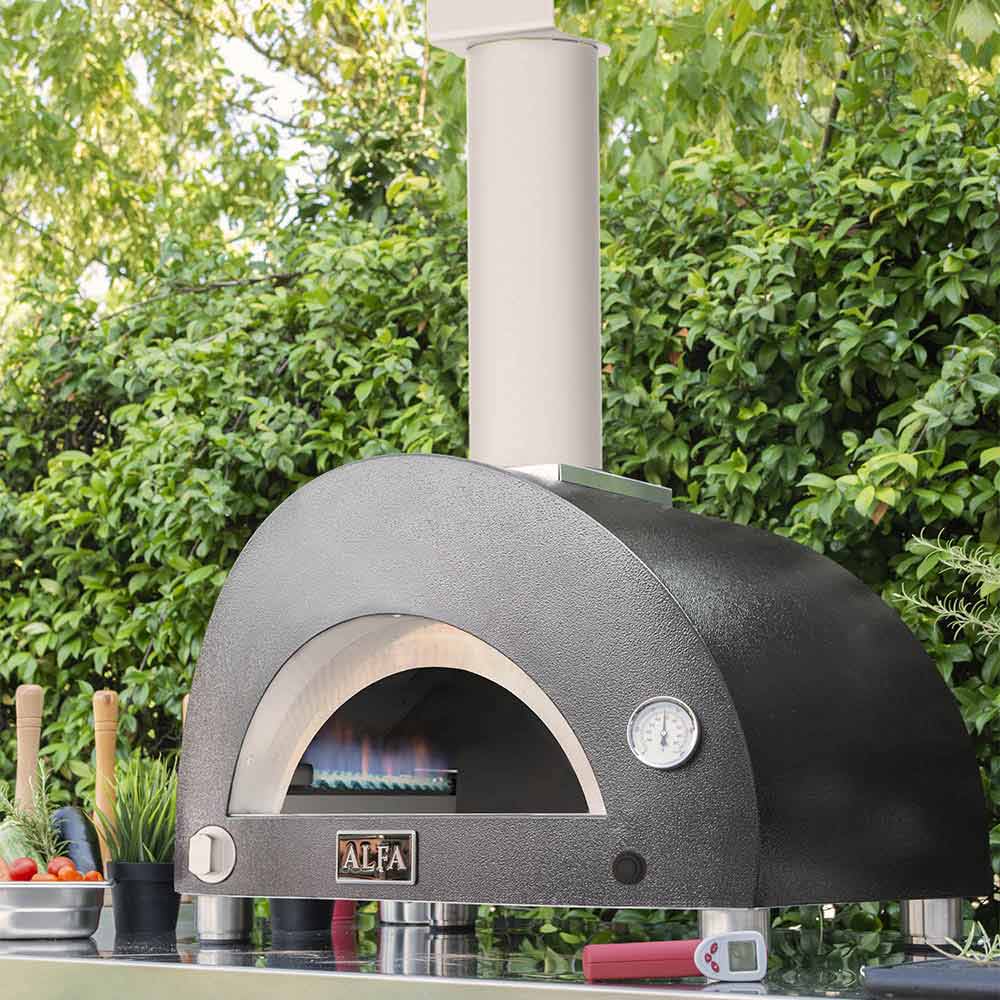 Freestanding gas pizza oven with black dome, arched door, and temperature gauge