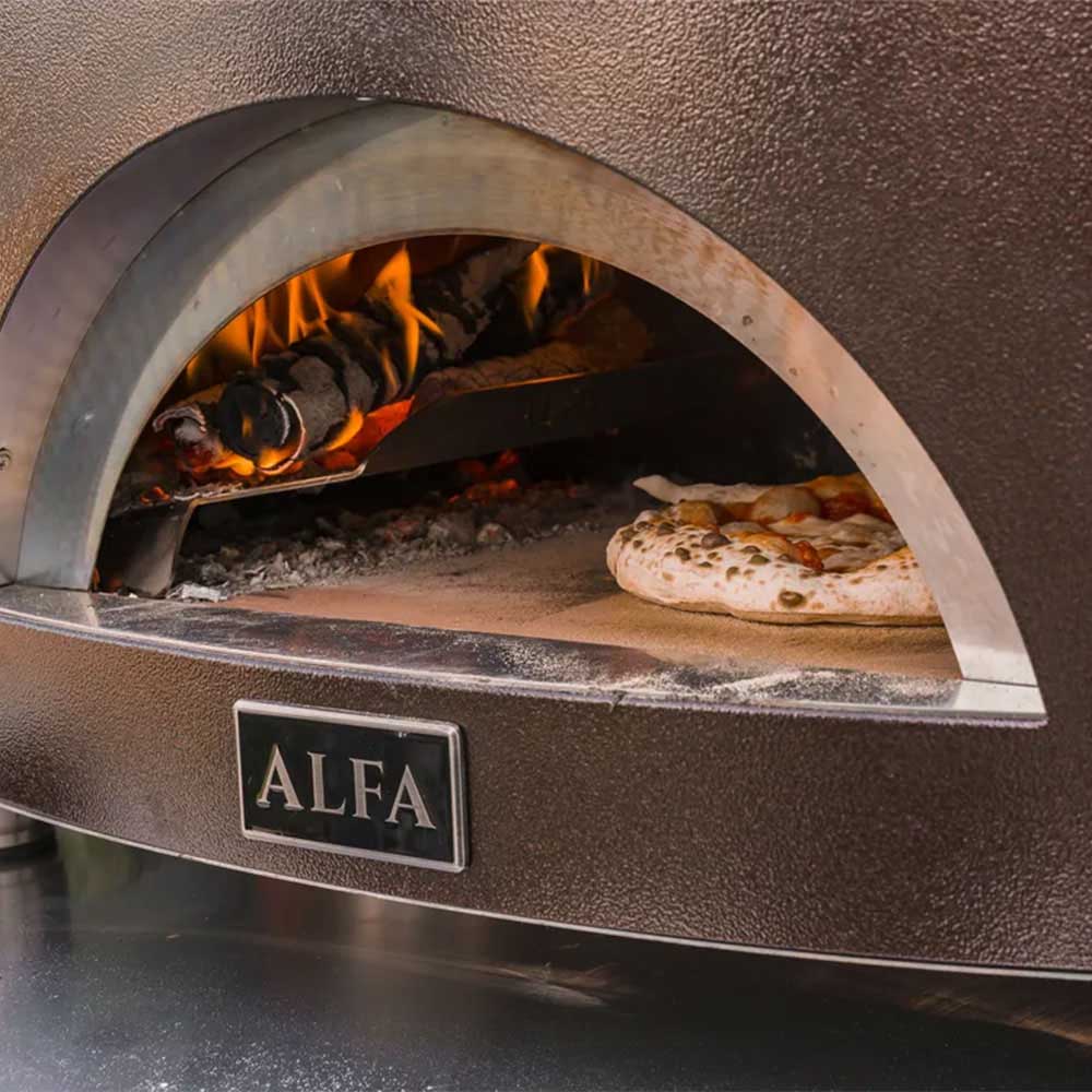 Gas pizza oven interior with glowing flames and pizza on the stone floor