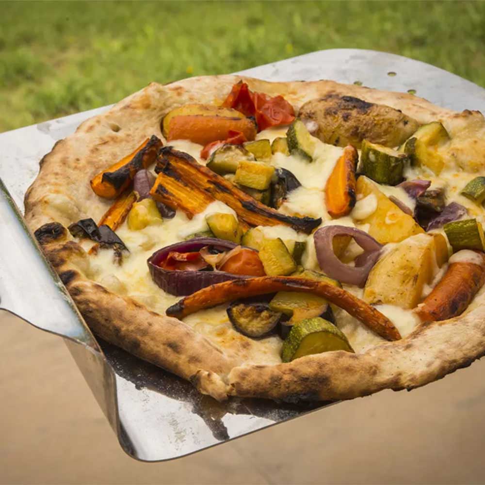 Vegetable pizza on metal pizza peel