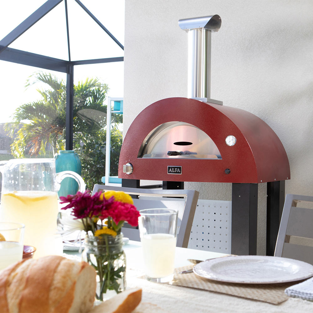Ruby red freestanding pizza oven with chimney and open front baking chamber