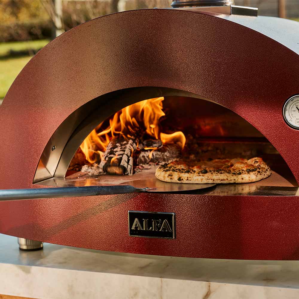 Red outdoor pizza oven with a pizza inside, brand 'ALFA' visible