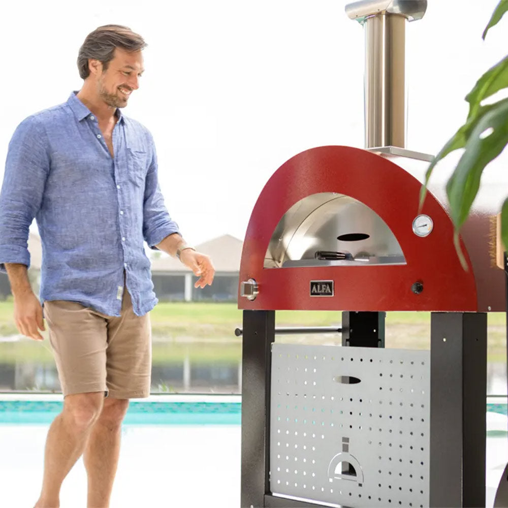Red freestanding wood-fired pizza oven with stainless chimney and arched cooking opening