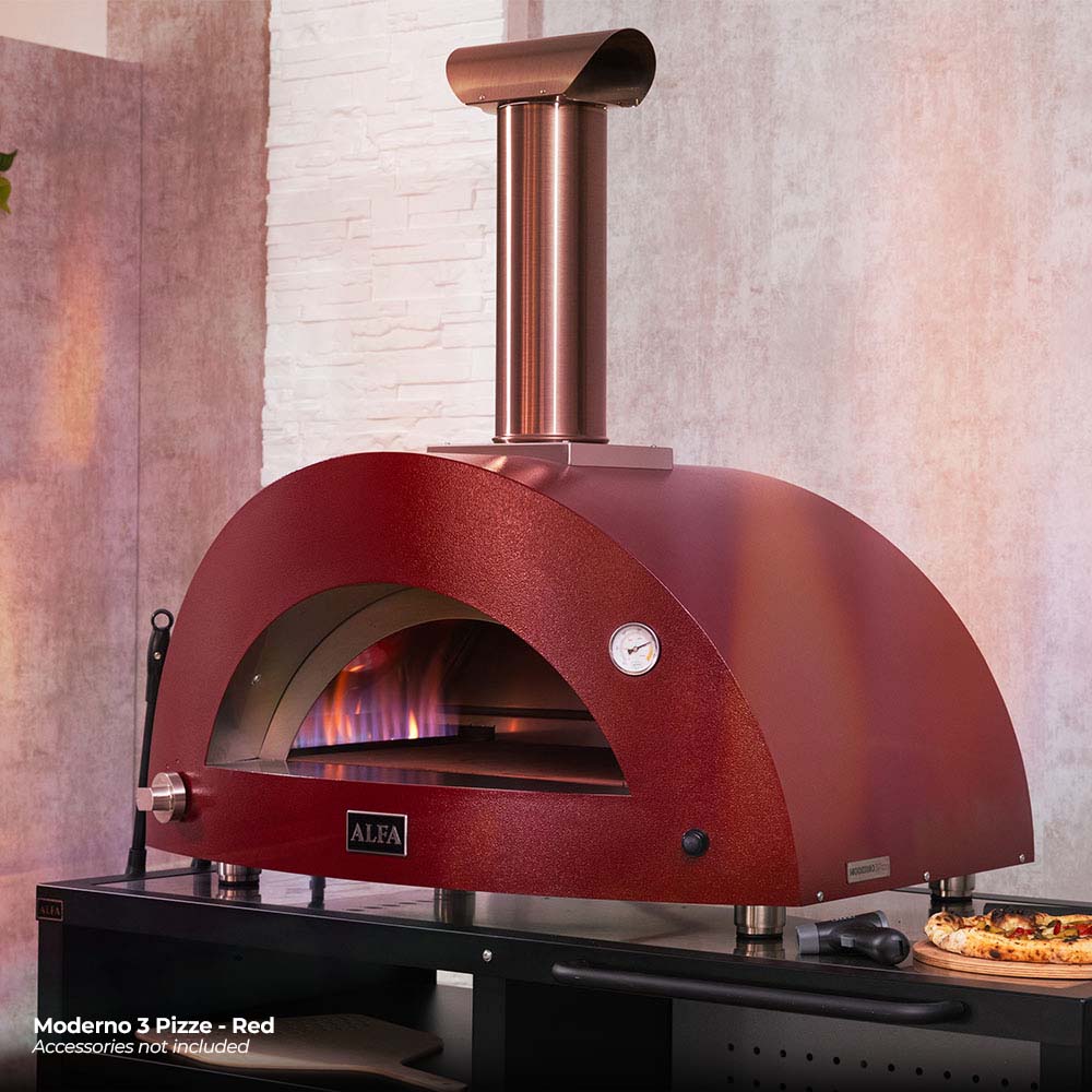 Ruby red gas pizza oven with glowing interior through arched opening and stainless chimney