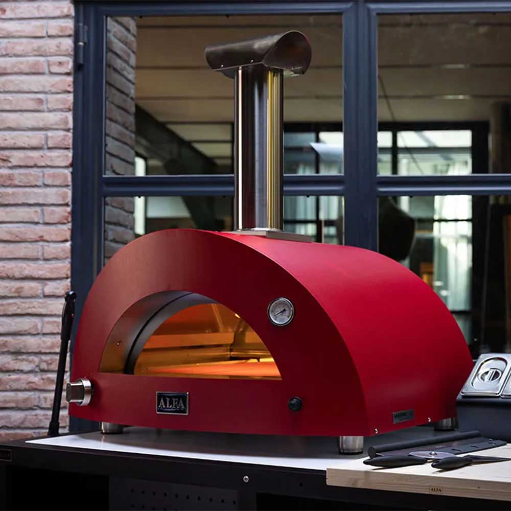 Ruby red gas pizza oven with stainless chimney, arched front, and black stand