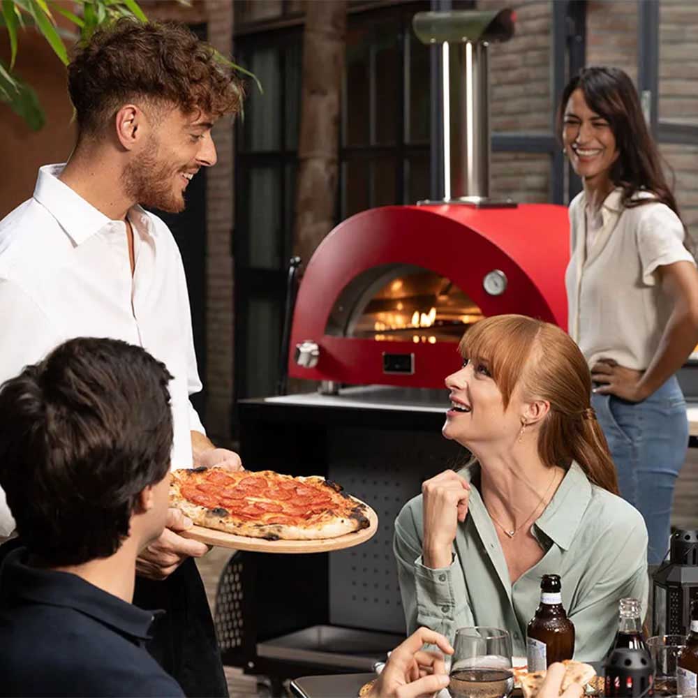 Alfa Moderno 3 Pizze gas pizza oven with red dome during outdoor cooking