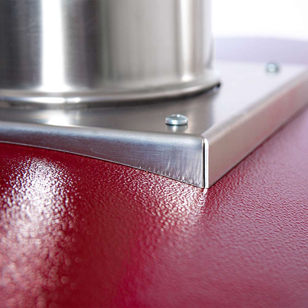 Stainless steel corner vent and rim on a red wood-fired pizza oven