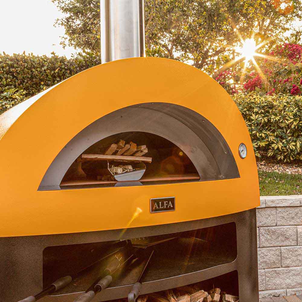 Freestanding gas pizza oven with yellow dome, open chamber, and metal heat shield