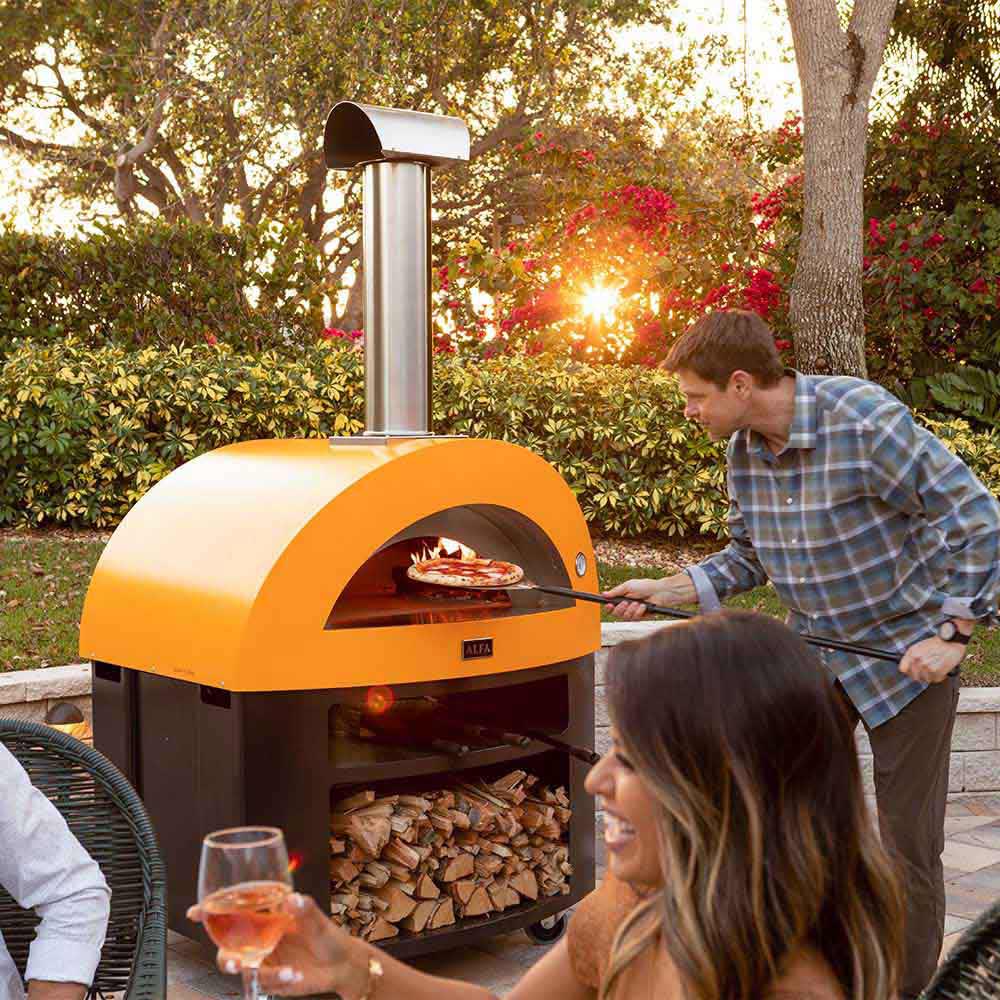 Yellow gas pizza oven with chimney, open mouth with pizza inside and people serving.