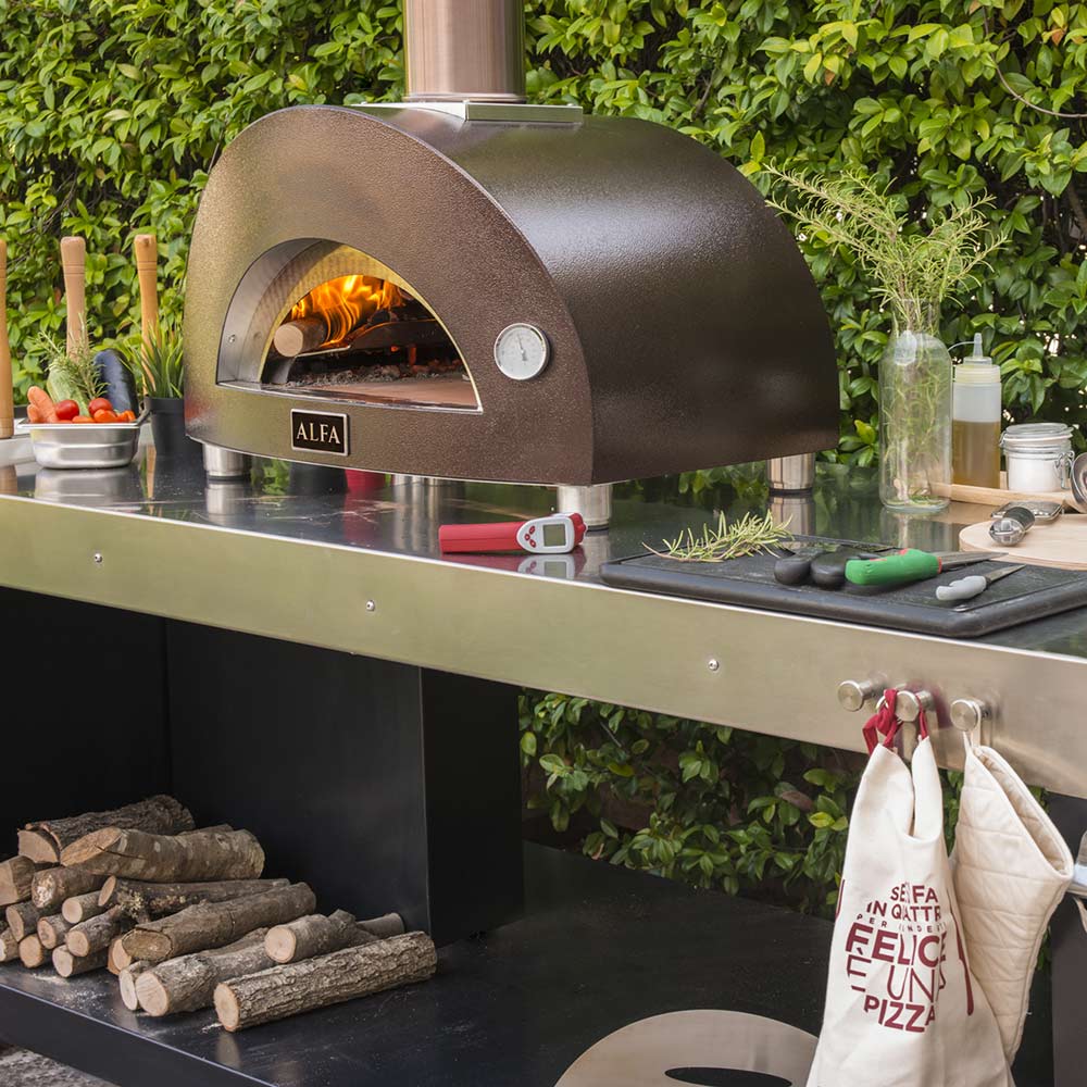 Wood-fired pizza oven with arched firebox, ALFA badge, and stainless counter station