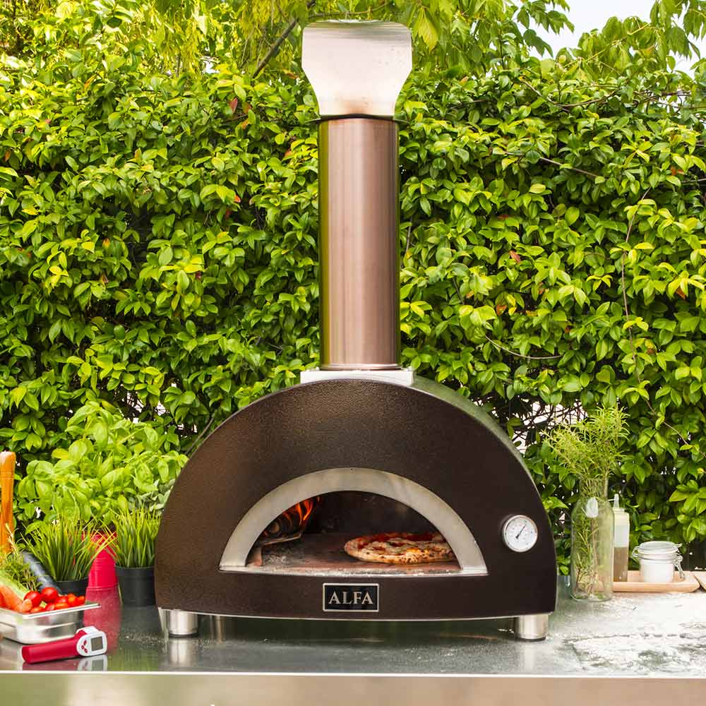 Wood-fired pizza oven on outdoor countertop with chimney pipe and arched front opening