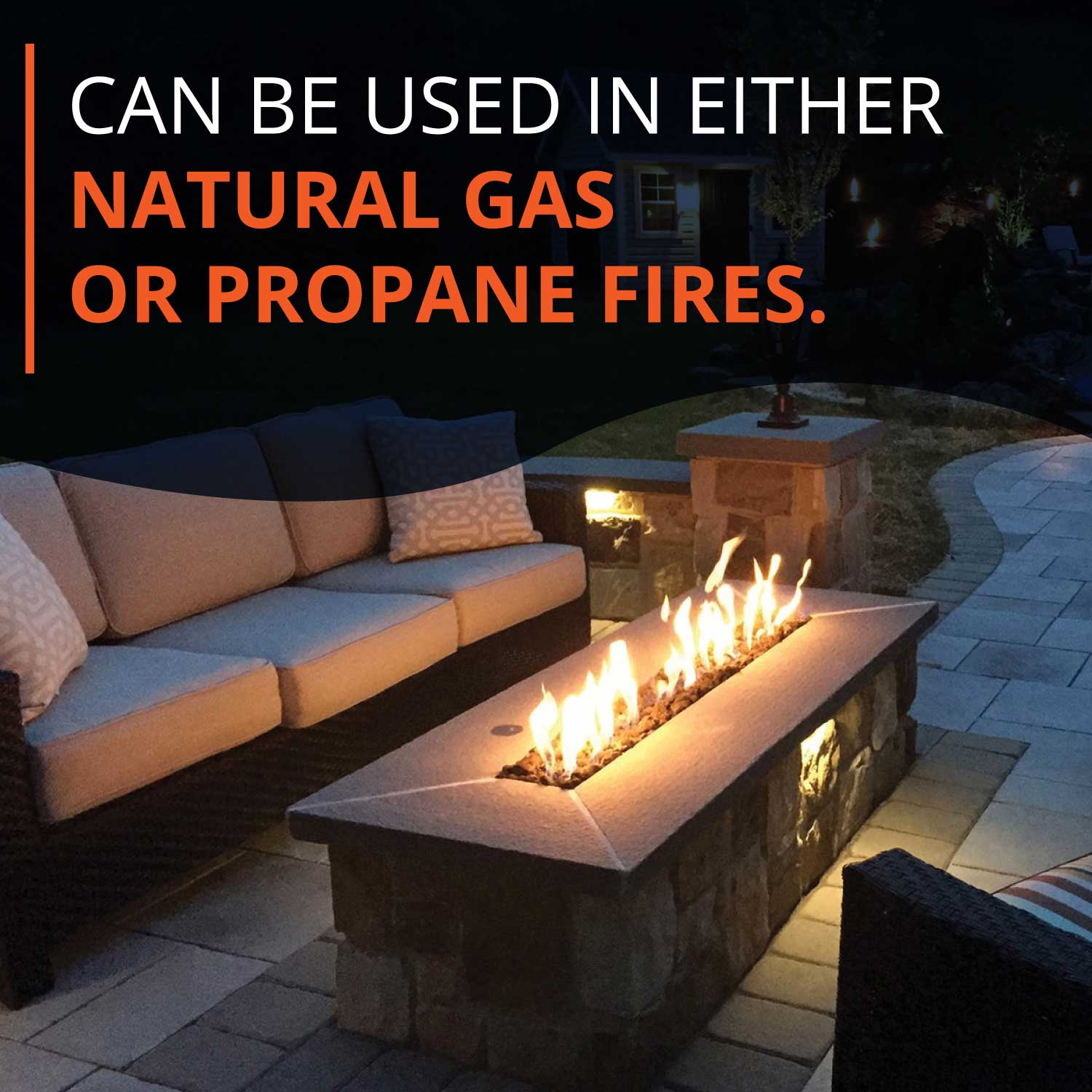 Decorative fire glass around burning flames in a fire pit
