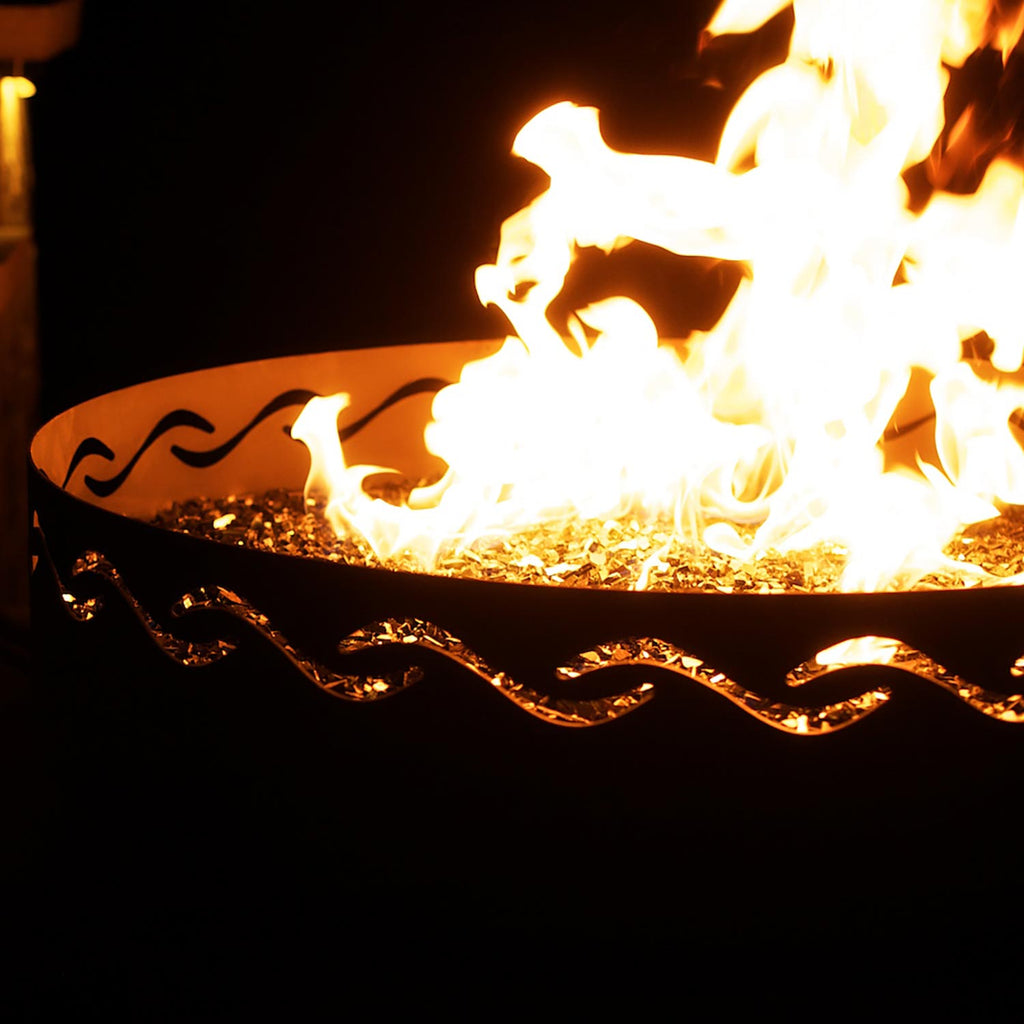 Close-up of gas fire pit flame in black metal bowl with orange trim