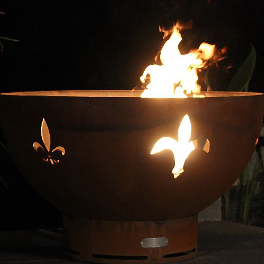 Gas fire pit bowl with flames and fleur de lis cutout silhouettes on the front