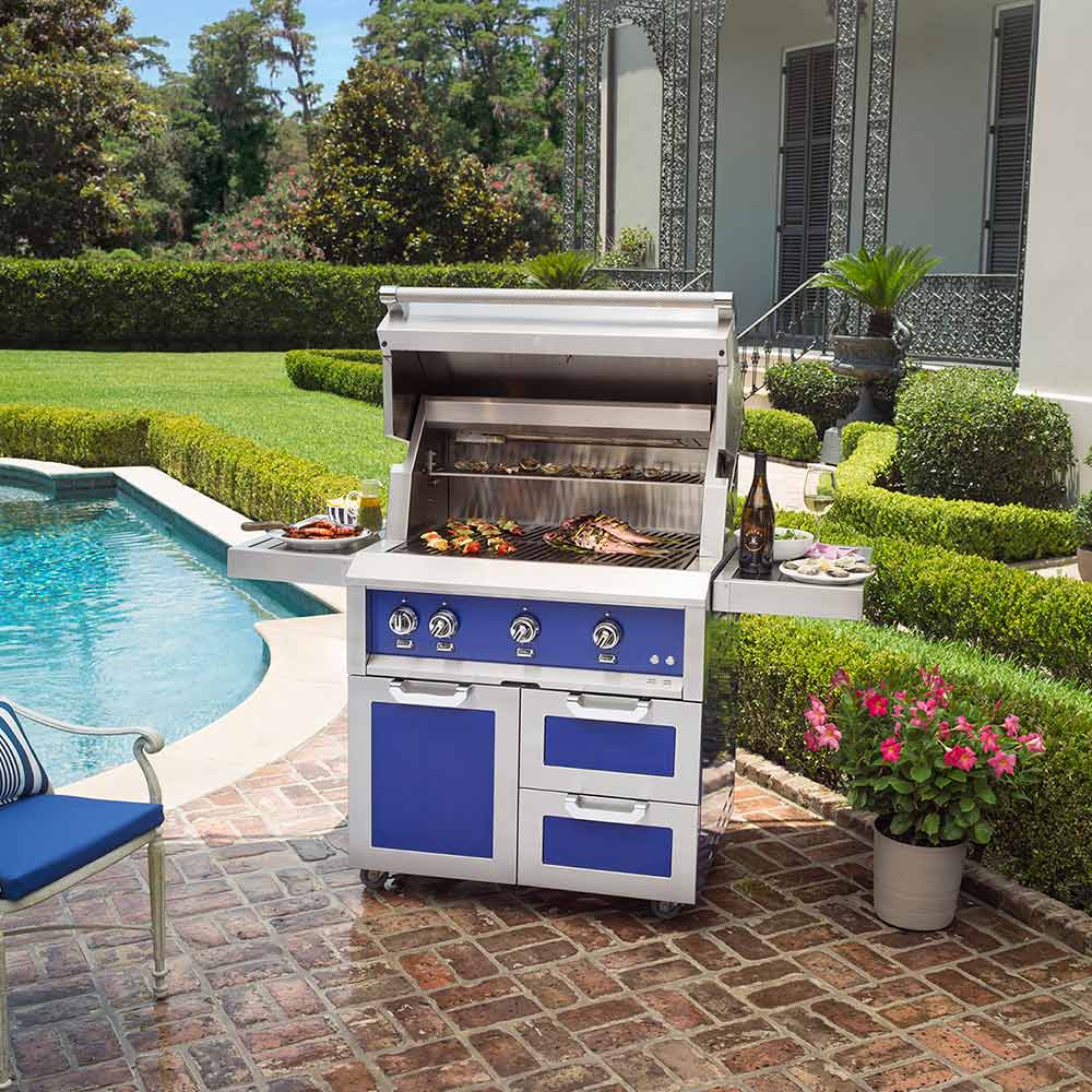 Hestan 42-inch freestanding gas grill with open lid and blue front panel accents