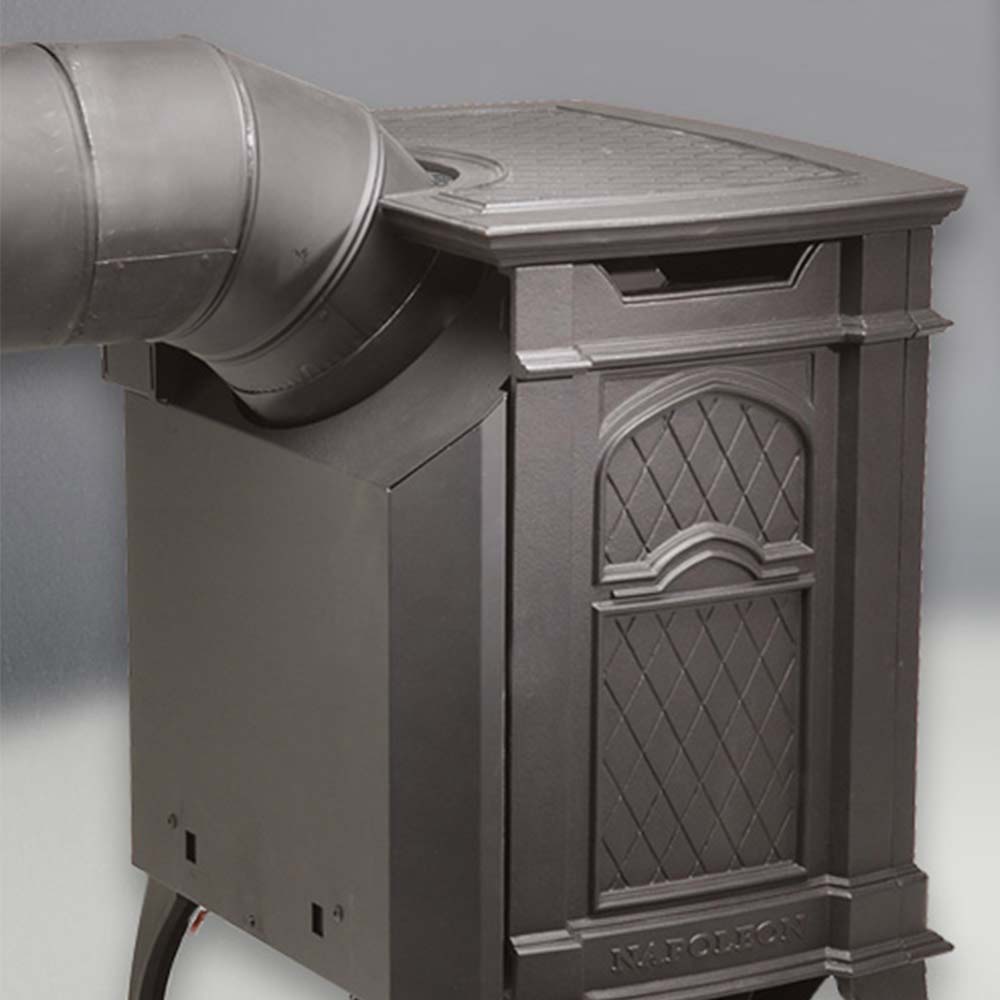 Direct vent gas stove side showing flue pipe and arched glass door panel