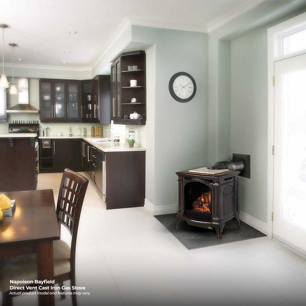 White cast iron direct vent gas stove with flame viewing window and safety screen