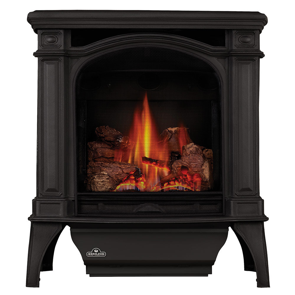 Cast iron gas stove with arched glass front and visible flames inside firebox