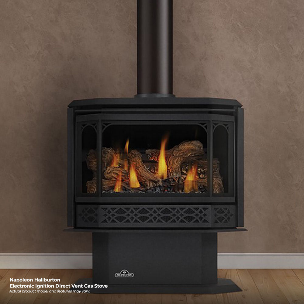 Black direct vent gas stove with glass door, glowing flames, and log bed